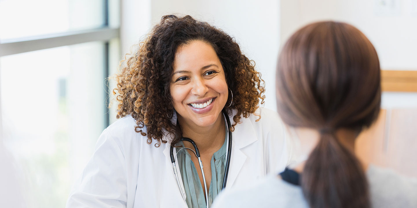 a smiling healthcare provider reviewing test results with a patient